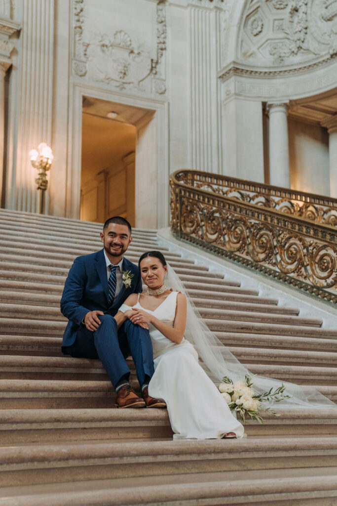 bride and groom on the magnificent steps for their san francisco city hall elopement