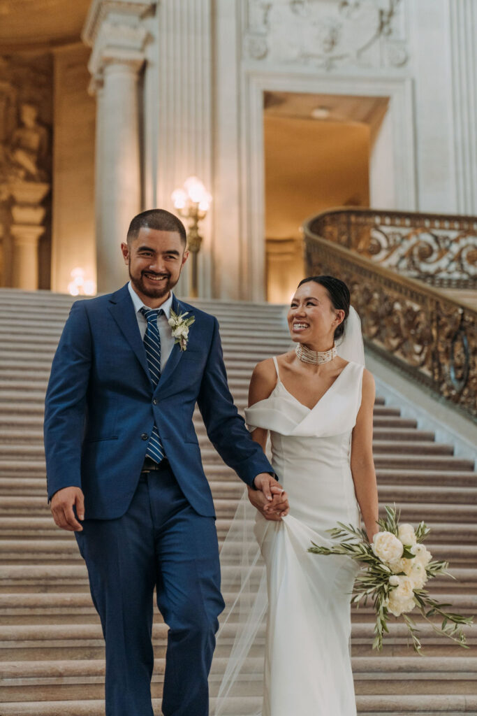 bride and groom on the magnificent steps for their san francisco city hall elopement